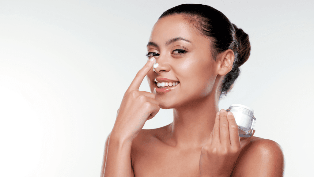 אישה עם שחורים באף שמה קרם לחות